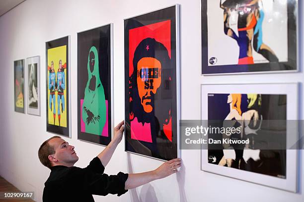 Curator puts the finishing touches to a series of iconic prints by Polish artist and graphic designer Roman Cieslewicz at the Royal Academy of Arts...