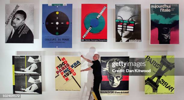 Curator Andrzej Klimowski puts the finishing touches to a display of work by Polish artist and graphic designer Roman Cieslewicz at the Royal Academy...