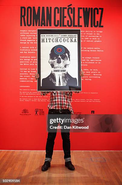 Curator holds a 1950's film poster designed by Polish artist and graphic designer Roman Cieslewicz at the Royal Academy of Arts on July 15, 2010 in...
