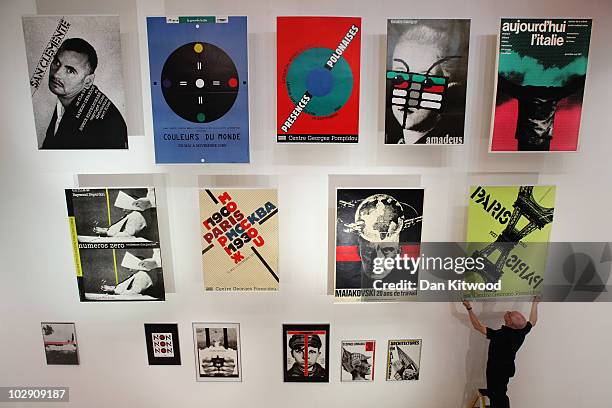 Curator Andrzej Klimowski puts the finishing touches to a display of work by Polish artist and graphic designer Roman Cieslewicz at the Royal Academy...
