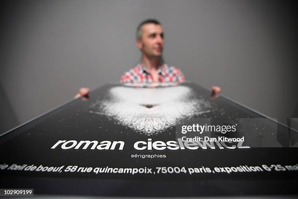 Curator David Crowley puts the finishing touches to an exhibition by Polish artist and graphic designer Roman Cieslewicz at the Royal Academy of Arts...