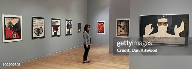 Woman stands in a gallery displaying work by Polish artist and graphic designer Roman Cieslewicz at the Royal Academy of Arts on July 15, 2010 in...