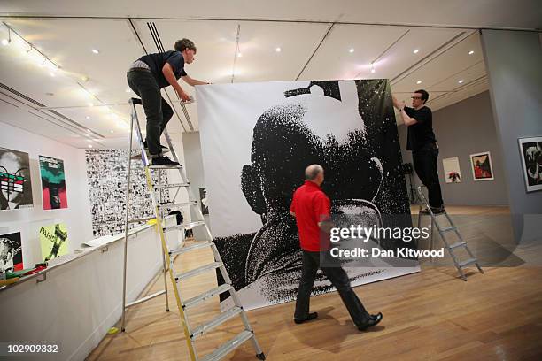 Curators put the finishing touches to an exhibition by Polish artist and graphic designer Roman Cieslewicz at the Royal Academy of Arts on July 15,...
