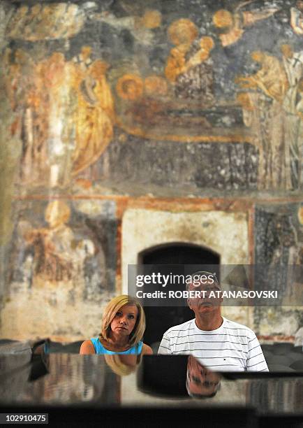 Latvia's President Valdis Zatlers and his wife Lilita Zatlere visit the church St Sofia during their official visit on July 15, 2010 in Ohrid. During...