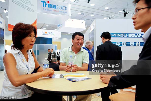 Liansheng Miao, chairman and chief executive officer of Yingli Green Energy, based in Baoding, China, center, talks with company employees at their...