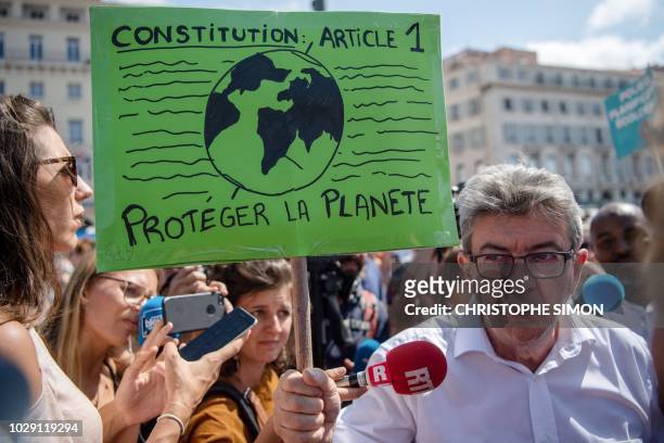 French member of Parliament and La France Insoumise far-left party leader Jean-Luc Melenchon addresses journalists as he takes part in a march on...
