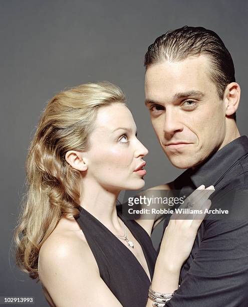 Singer Robbie Williams with Kylie Mingoue pose for a portrait shoot on the set for the music video Kids by photographer Hamish Brown in Shepperton in...