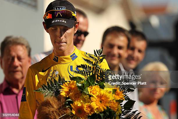 Luxembourg's Andy Schleck, wearing the race leaders yellow jersey, stands on the podium after stage 11 of the Tour de France July 15, 2010 in...