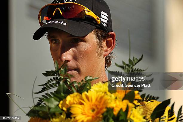 Luxembourg's Andy Schleck, wearing the race leaders yellow jersey, stands on the podium after stage 11 of the Tour de France July 15, 2010 in...
