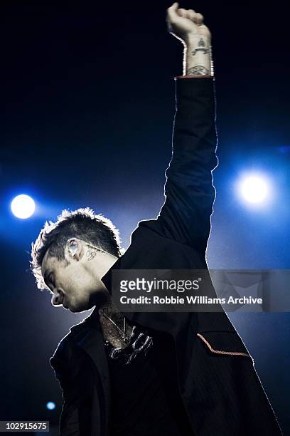 Singer Robbie Williams performing in concert during the Close Encounters tour shot by photographer Simon Niblett in Melbourne in 2006.