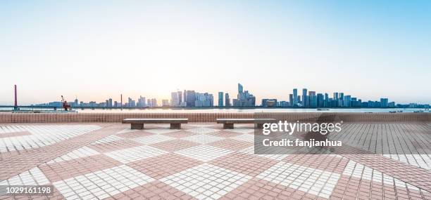 empty bench front of shenzhen cityscape - urban areas　water front stockfoto's en -beelden