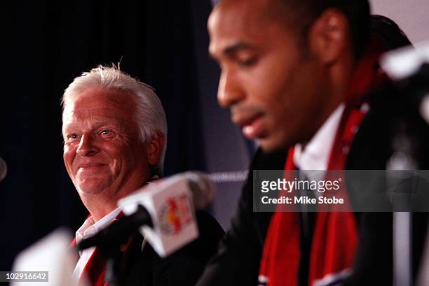 Head Coach Hans Backe looks on as Thierry Henry speaks to the media during a press conference on July 15, 2010 at Red Bull Arena in Harrison, New...