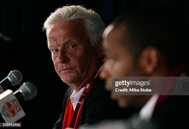 Head Coach Hans Backe looks on as Thierry Henry speaks to the media during a press conference on July 15, 2010 at Red Bull Arena in Harrison, New...