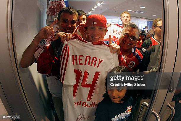 Fans of Thierry Henry celebrate during a press conference on July 15, 2010 at Red Bull Arena in Harrison, New Jersey.