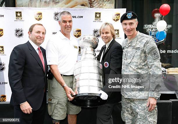Commissioner Gary Bettman , retired Sgt. Joseph Bowser, Phil Pritchard and Lt. Gen. David Huntoon, Jr. Pose with the Stanley cup at the NHL, UPS &...