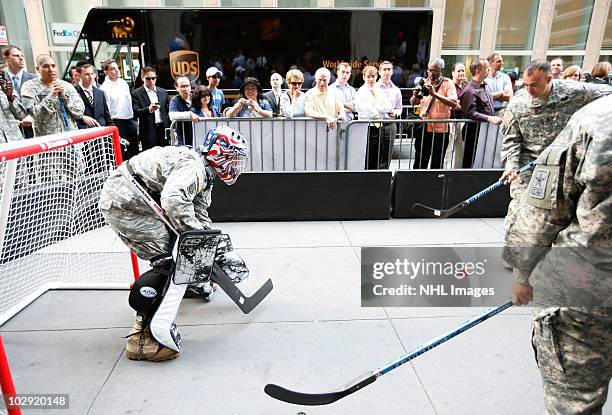 Members of the US Army play street hockey with equipment donated to troops in Iraq at the NHL Powered by Reebok Store on June 7, 2010 in New York.