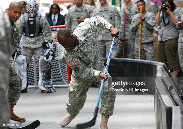 Members of the US Army play street hockey with equipment donated to troops in Iraq at the NHL Powered by Reebok Store on June 7, 2010 in New York.