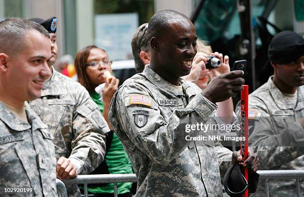 Soldiers watch their fellow troops play street hockey at NHL, UPS & U.S. Army Street Hockey Equipment Donation To Troops In Iraq at NHL Powered by...