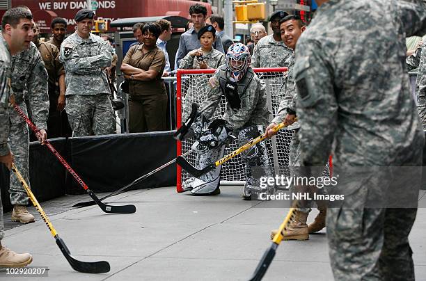 Members of the US Army play street hockey with equipment donated to troops in Iraq at the NHL Powered by Reebok Store on June 7, 2010 in New York.