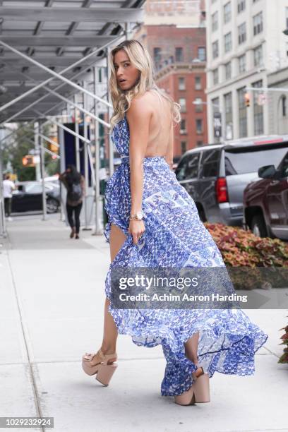 Daniella Duque is seen wearing a blue Shopolamoon dress, beige Sapatinho De Luxo shoes, and a light blue Kate Jules purse on the street during New...