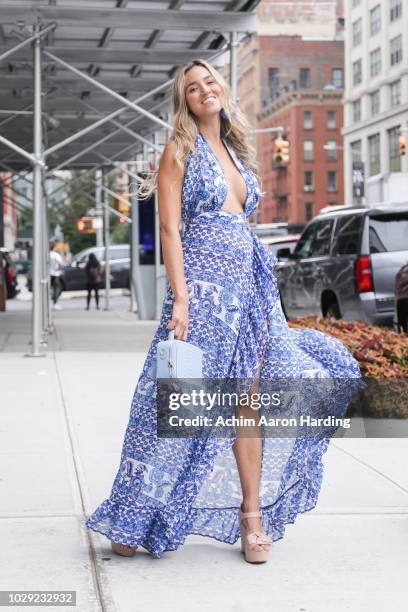 Daniella Duque is seen wearing a blue Shopolamoon dress, beige Sapatinho De Luxo shoes, and a light blue Kate Jules purse on the street during New...