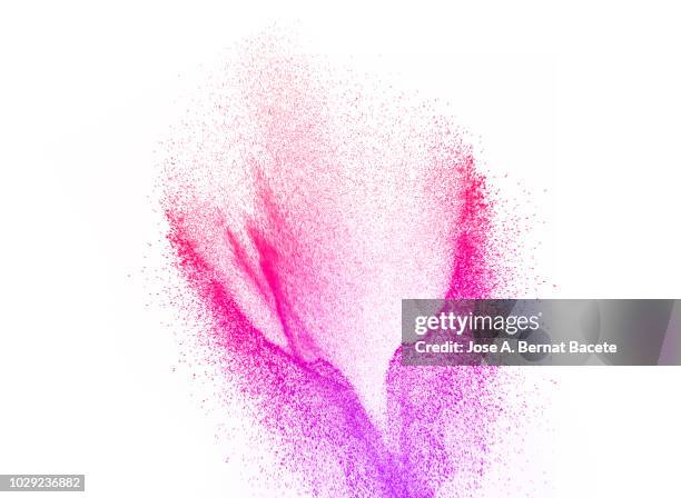 explosion by an impact of a cloud of particles of powder of color red and violet on a white background. - colour powder explosion stockfoto's en -beelden