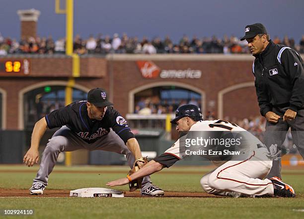 David Wright of the New York Mets tags out Aubrey Huff of the San Francisco Giants after Huff slide past third base in the sixth inning at AT&T Park...