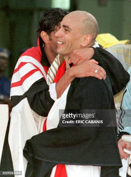 Egytian Ramzy Hany hugs his captain Hassan Hossam after their victory 28 February at the August 4 stadium in Ouagadougou during the final of the...