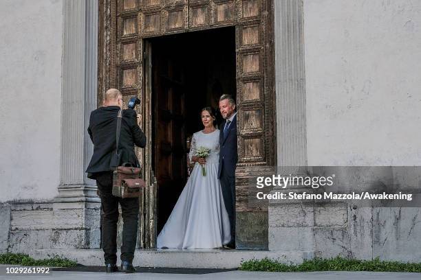 Luxembourg-born actress Desiree Nosbusch, wearing a dress by MINX, and German cameraman Tom Alexander Bierbaumer exit from the church of Oderzo after...
