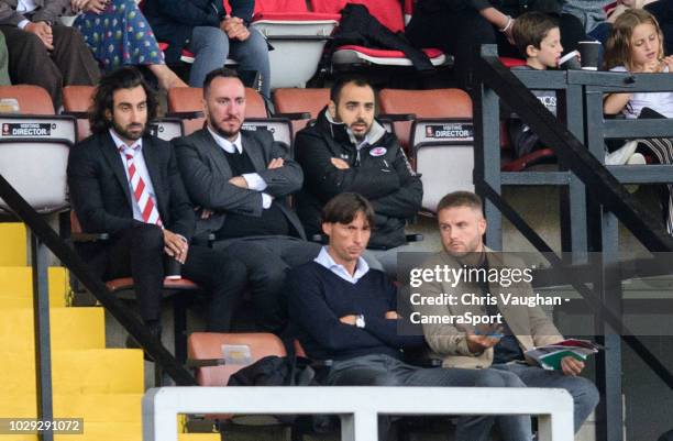 Crawley Town manager Gabriele Cioffi, front left, watches the game from the stand during the Sky Bet League Two match between Lincoln City and...