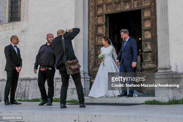 Luxembourg-born actress Desiree Nosbusch, wearing a dress by MINX, and German cameraman Tom Alexander Bierbaumer exit from the church of Oderzo after...