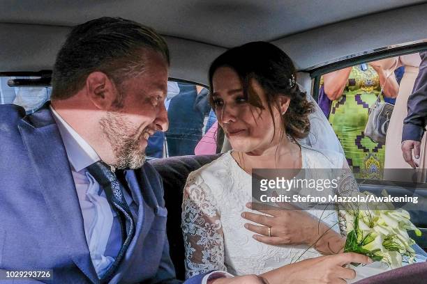 Luxembourg-born actress Desiree Nosbusch and German cameraman Tom Alexander Bierbaumer sit in a car as the leave the church following their marriage...