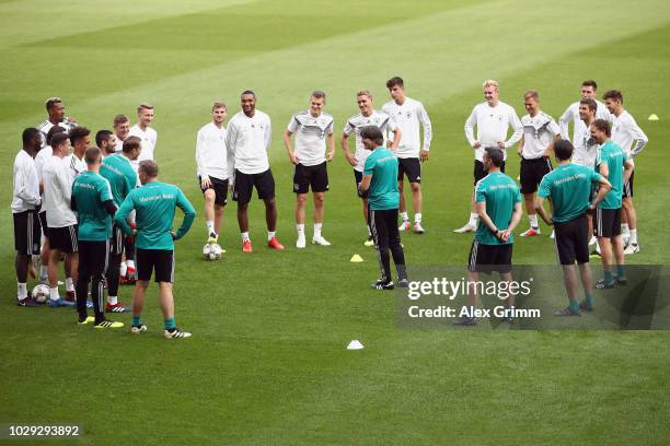 Head coach Joachim Loew talks to the players during a Germany training session ahead of their International Friendly match against Peru at...