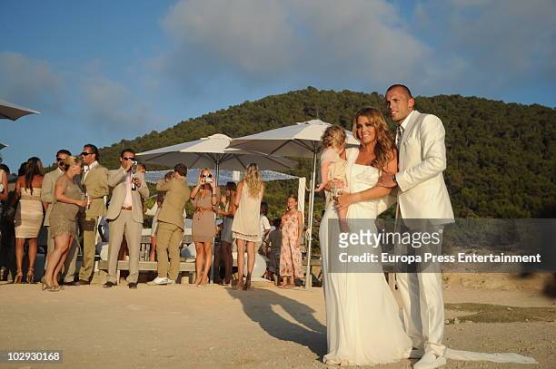 Dutch football player John Heitinga, Charlotte Sophie Zenden and their daughter Jezabel pose at their wedding on July 15, 2010 in Ibiza, Spain.