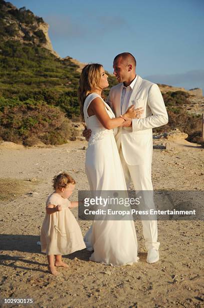 Dutch football player John Heitinga, Charlotte Sophie Zenden and their daughter Jezabel pose at their wedding on July 15, 2010 in Ibiza, Spain.