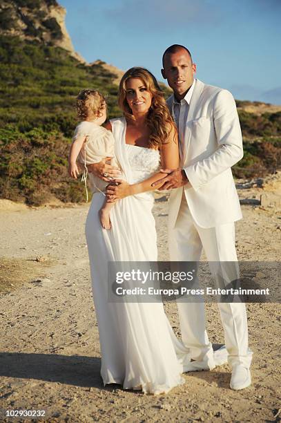 Dutch football player John Heitinga, Charlotte Sophie Zenden and their daughter Jezabel pose at their wedding on July 15, 2010 in Ibiza, Spain.