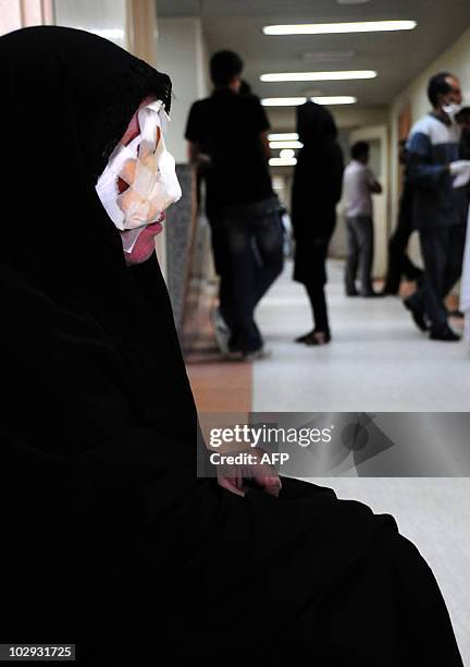 Wounded Iranian woman rests at a hospital in the southeastern city of Zahedan on July 16 a day after twin suicide bombings targeted a Shiite mosque,...