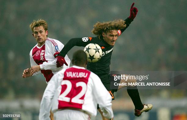 Roma's Francesco Totti fights for a ball with Ajax's Abubakari Yakubu and Andre Bergdoelmo during their Champions League match in the Amsterdam...