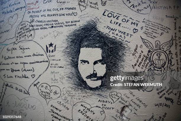 Messages are written on a Queen rock band tribute wall outside the Casino Barriere on September 8, 2018 in Montreux. - Queen fans gather every year...