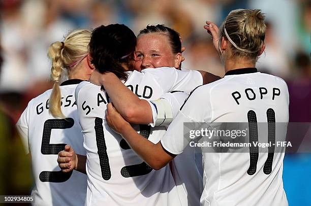 Marina Hegering of Germany celebrates scoring the third goal with Alexandra Popp and Sylvia Arnold during the FIFA U20 Women's World Cup Group A...