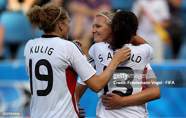 Sylvia Arnold of Germany celebrates scoring the second goal with Alexandra Popp and Kim Kulig during the FIFA U20 Women's World Cup Group A match...