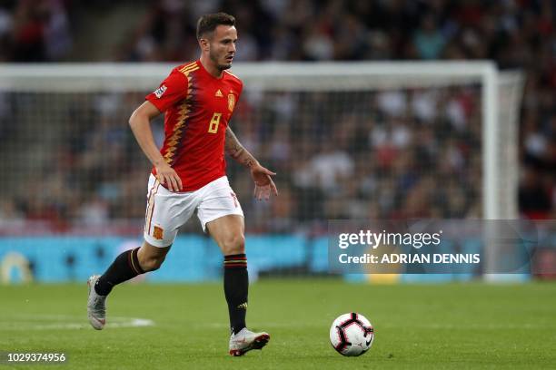 Spain's midfielder Saul Niguez runs with the ball during the UEFA Nations League football match between England and Spain at Wembley Stadium in...