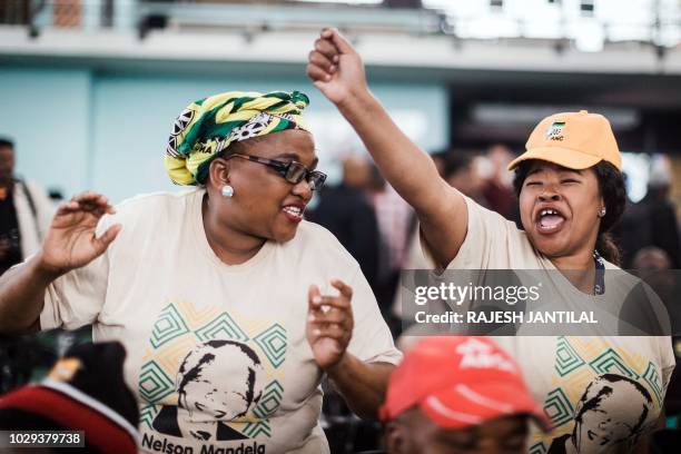 South African ruling party African National Congress members and supporters sing and dance during a meeting of the South African ruling Party African...