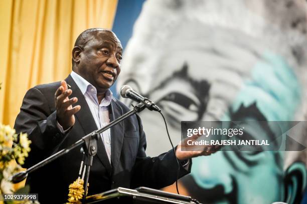 South African President Cyril Ramaphosa delivers a speech on stage during a meeting of the South African ruling Party African National Congress...
