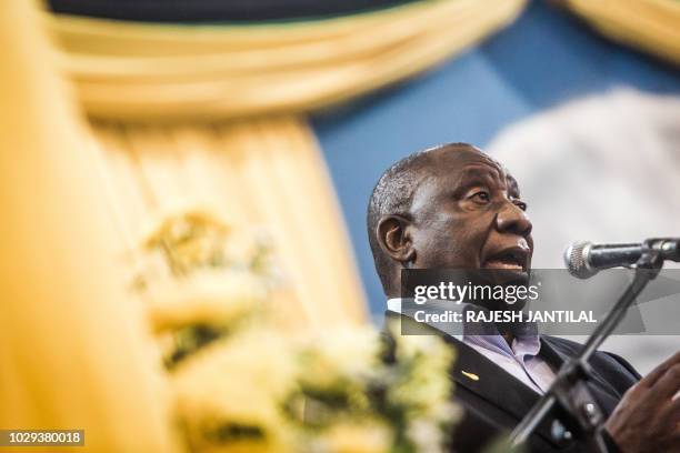South African President Cyril Ramaphosa delivers a speech on stage during a meeting of the South African ruling Party African National Congress...