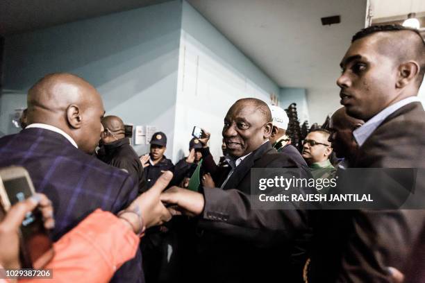 South African President Cyril Ramaphosa greets supporters upon his arrival for a meeting of the South African ruling Party African National Congress...