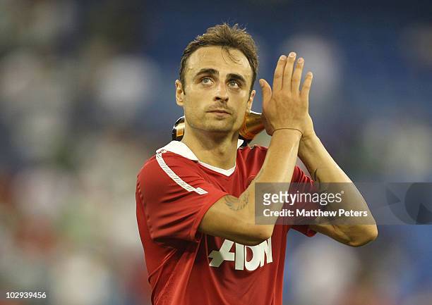 Dimitar Berbatov of Manchester United applauds the fans while holding his Man of the Match award after the pre-season friendly match between...