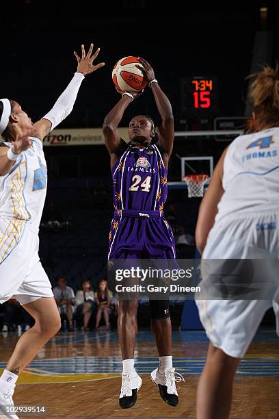 Marie Ferdinand-Harris of the Los Angeles Sparks shoots past Tamera Young and Christi Thomas of the Chicago Sky during the WNBA game on July 16, 2010...