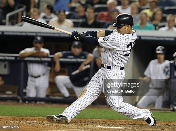 Nick Swisher of the New York Yankees hits a home run in the eighth inning against the Tampa Bay Rays on July 16, 2010 at Yankee Stadium in the Bronx...