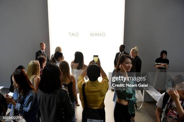 Guests take photos on their cel phones at the Taoray Wang show in gallery II during New York Fashion Week: The Shows on September 8, 2018 in New York...